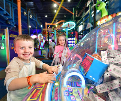 boy and girl playing in the arcade